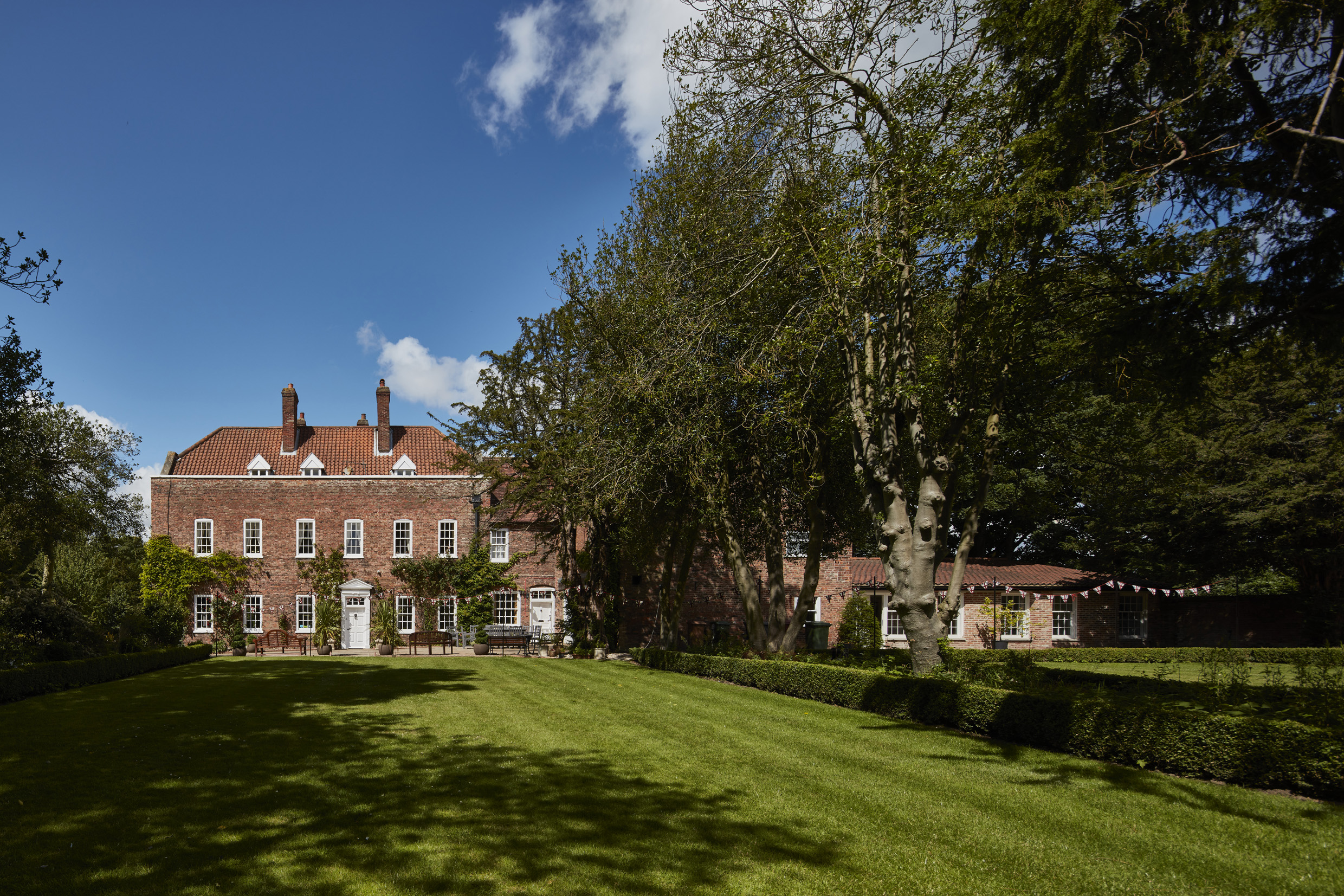 Picturesque lawned gardens in rural gardens of Bardney Hall wedding venue